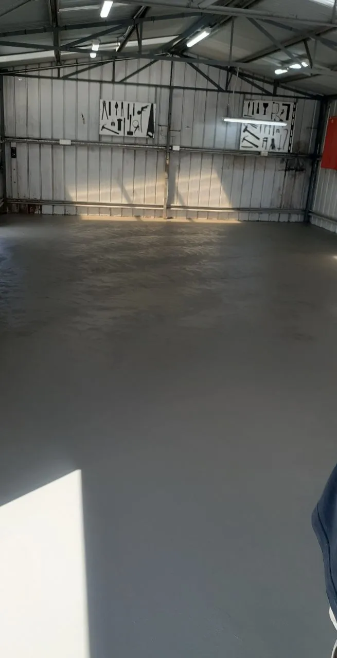 Finished concrete floor inside a large steel shed